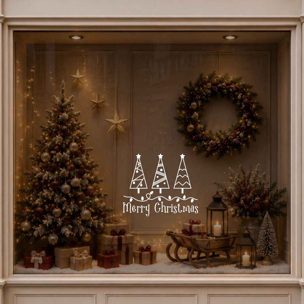 Merry Christmas tree window decal displayed on a warmly decorated festive shop window.