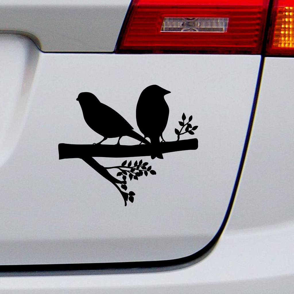 Black two birds on a branch decal on a white vehicle tailgate.