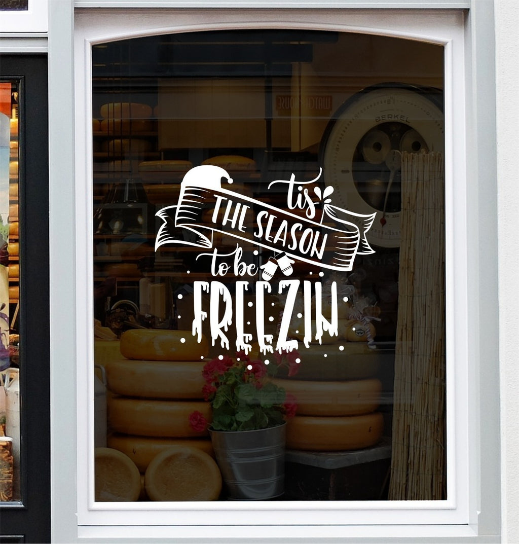 Tis the Season to Be Freezin vinyl window sticker design with winter hat and snowflakes