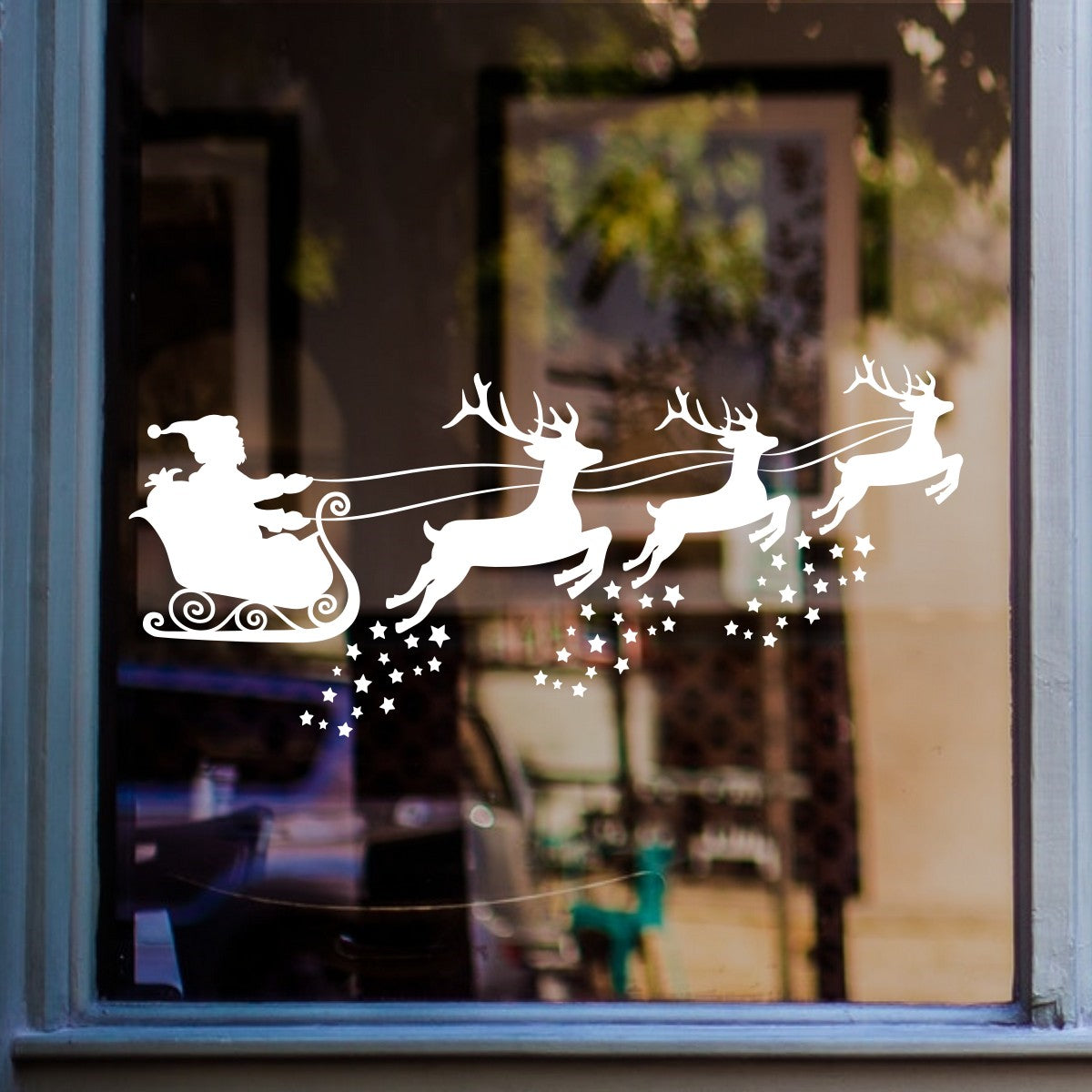 White Santa sleigh and reindeer Christmas sticker on a shop window