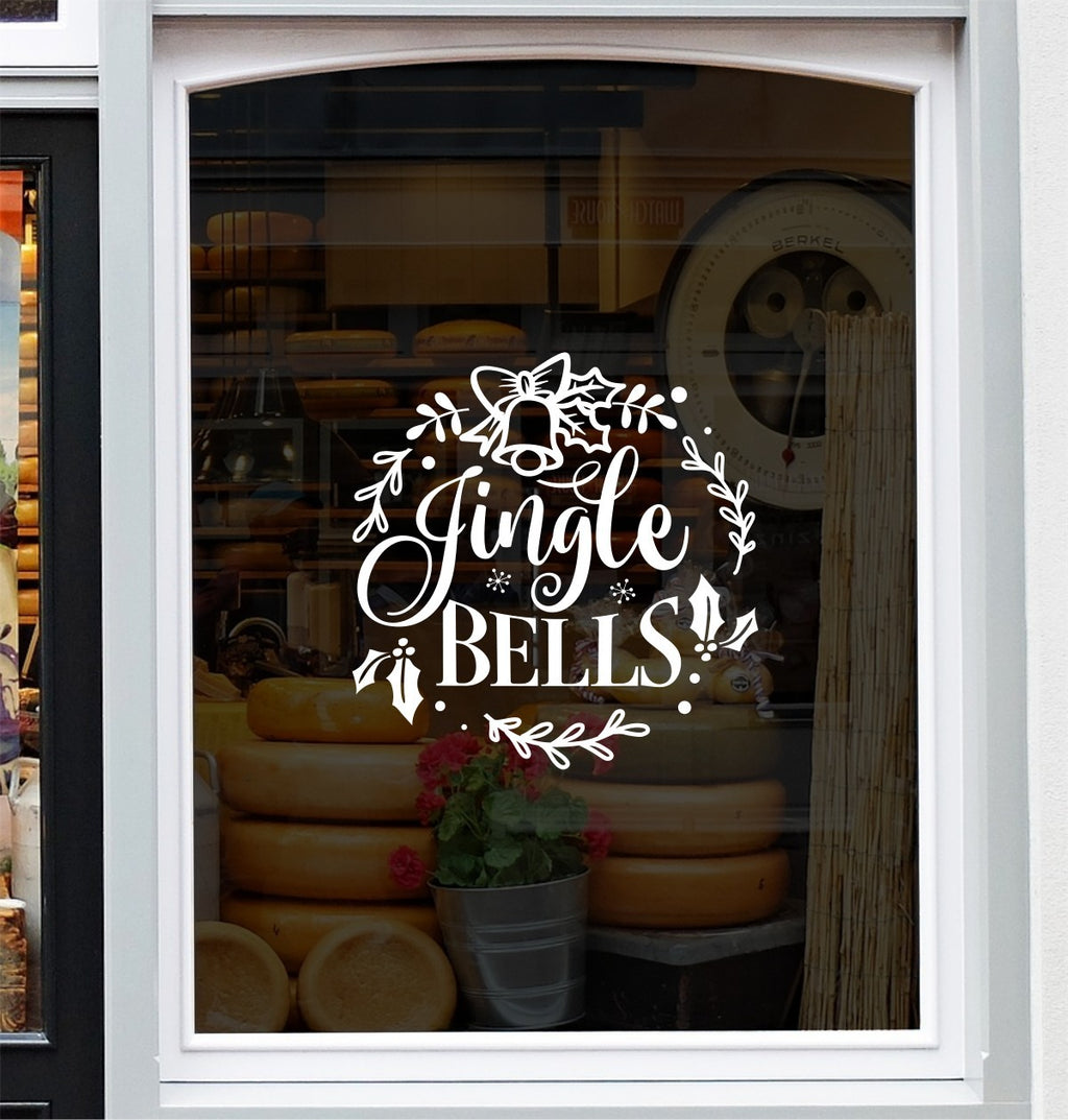 White Jingle Bells festive vinyl decal on a bakery shop window