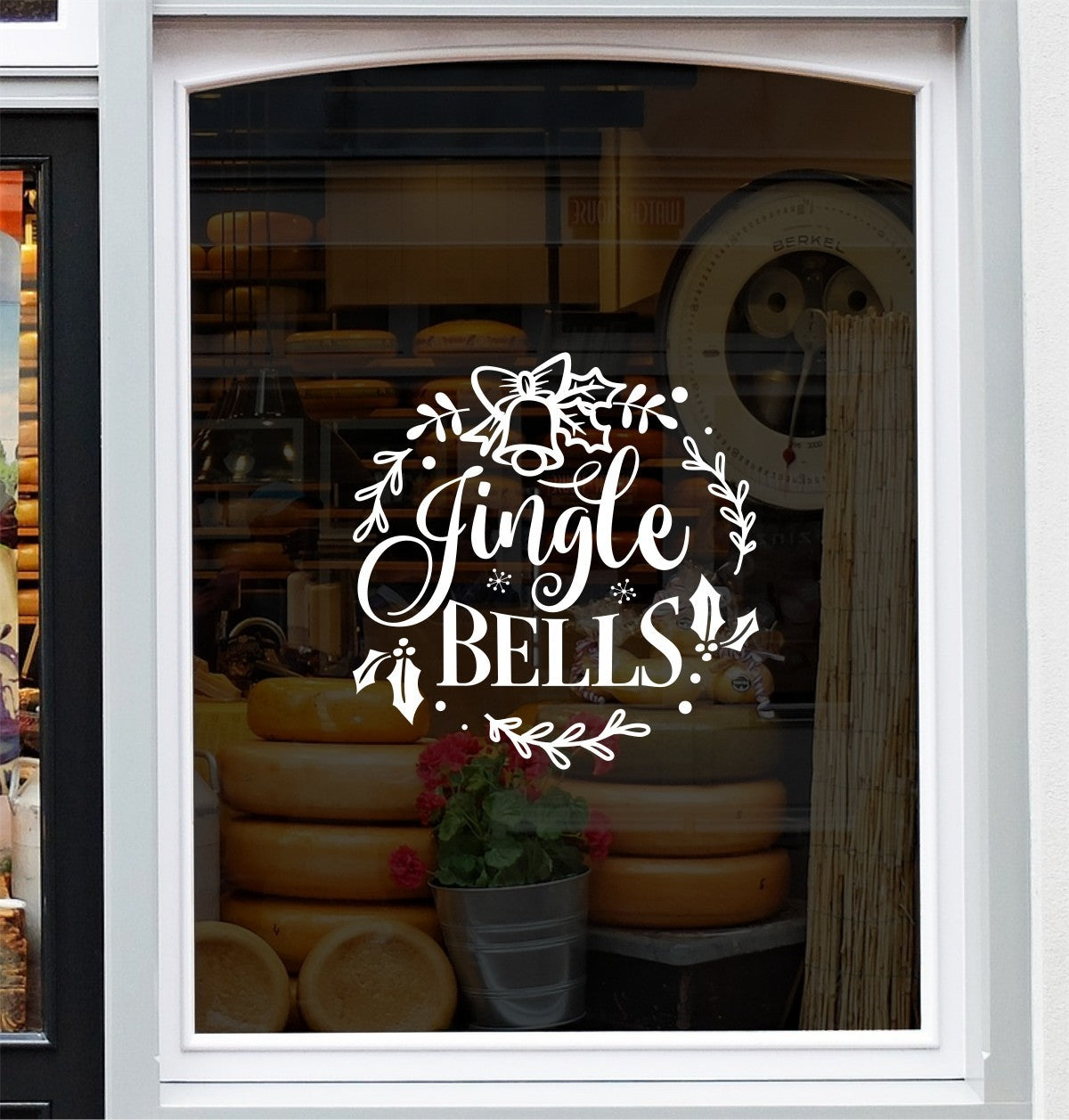 White Jingle Bells festive vinyl decal on a bakery shop window