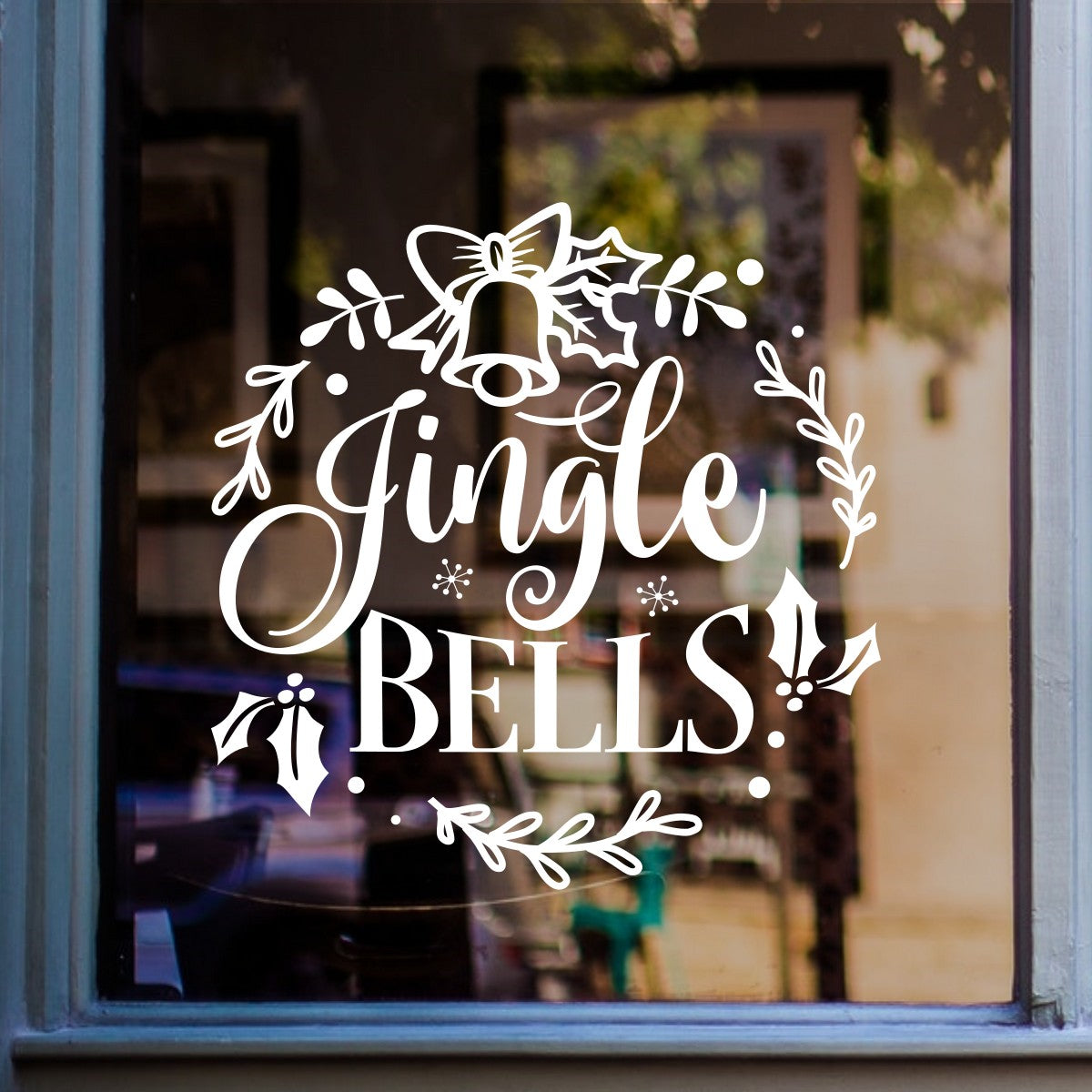 White Jingle Bells Christmas vinyl sticker displayed on a home window