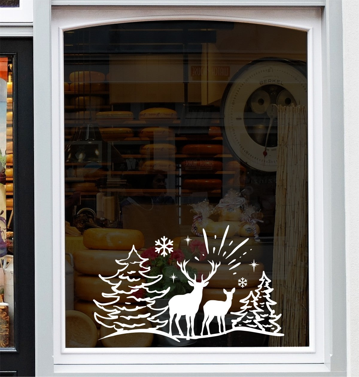 White reindeer Christmas woodland vinyl decal on a shop window