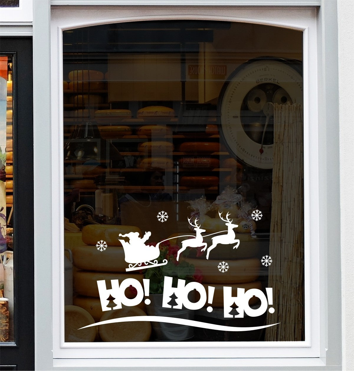 White HO HO HO Santa sleigh Christmas vinyl decal on a window