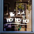 White HO HO HO Santa sleigh and reindeer sticker displayed on a shop window