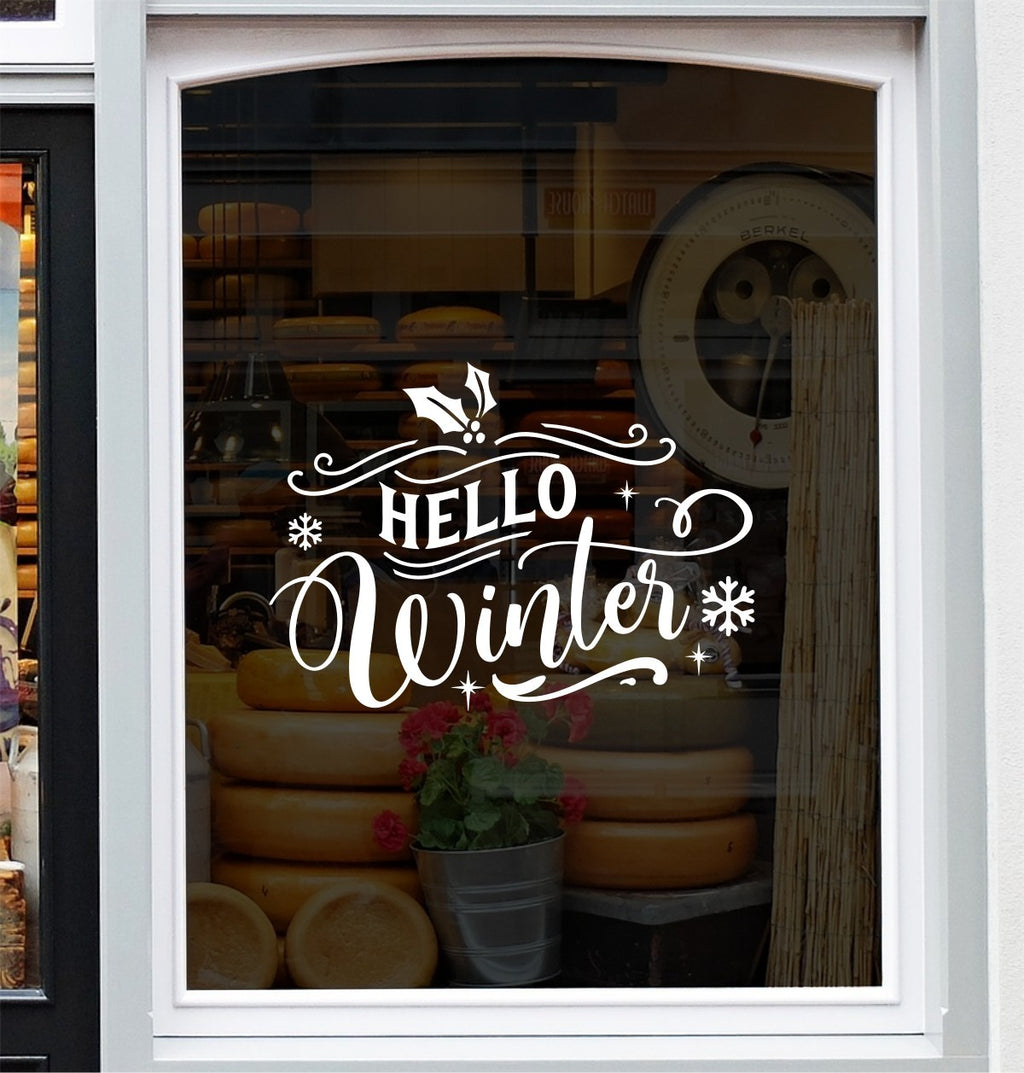 White Hello Winter festive window sticker displayed on glass