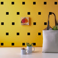 Square wall stickers arranged as a room display